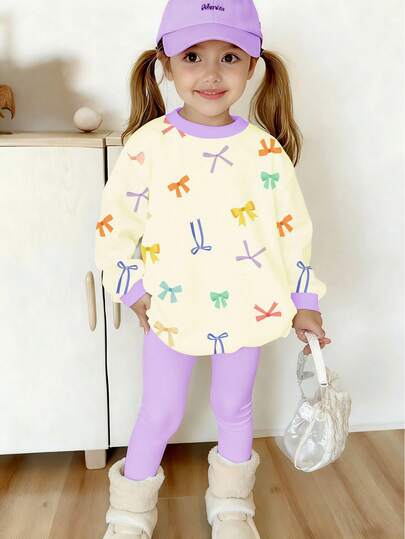 2pcs/Set Young Girls' Casual Cute Colorful Bow Print Crew Neck Long Sleeve Sweatshirt And Purple Leggings Set, Suitable For 4-7 Years Old Girls In Autumn/Winter. Not Only With Excellent Wearing Performance, But Also Soft And Skin-Friendly. The Overall Set Is Simple Yet Fashionable, Allowing The Child To Be The Most Eye-Catching Little Friend In The Autumn And Winter Seasons.