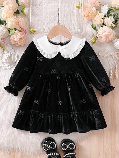 Souflis Souflis 女婴娃娃领荷叶边蝴蝶结泡泡袖A字连衣裙。娃娃领设计，可爱又时尚。3D蝴蝶结和泡泡袖，经典A字廓形，精致优雅。无论是带宝宝外出玩耍还是参加派对，这条裙子都能让宝宝成为众人瞩目的焦点。