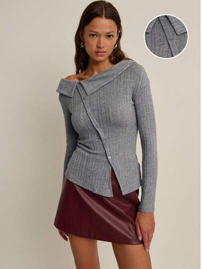 Nöista Chic Grey Ribbed Knit Top With An Asymmetric Button-Up Design And Wide Off-Shoulder Collar. Effortlessly Elegant And Modern, Perfect For Winter Outfits, Christmas Gatherings, Or A New Year Look. A Versatile Piece To Pair With Skirts Or Tailored Pants For An Elevated Chic Women's Outfit.