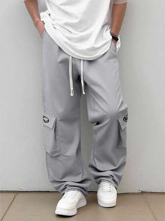 Street Life Pantalones cargo casuales unisex para otoño/invierno con bolsillos acordeón, pantalones tejidos con estampado gráfico en inglés americano de estilo callejero