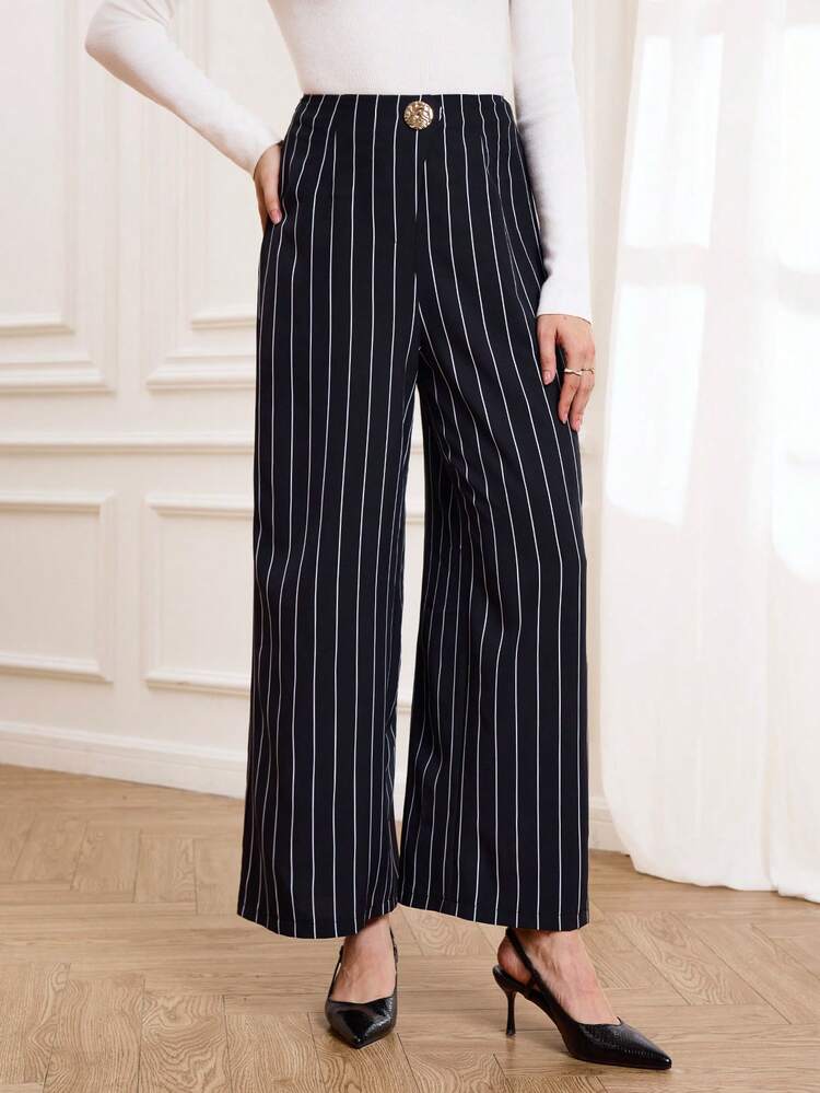 These Elegant Women's Trousers Feature A Sophisticated Navy Blue Base With White Vertical Stripes, Perfectly Complementing The Refined Atmosphere Of The New Year While Exuding A Sleek And Stylish Feel. The Simple Vertical Stripe Pattern Visually Elongates The Legs And Adds A Touch Of Sophistication. The High-Waisted, Wide-Leg Design, Adorned With Gold Buttons For Added Detail And Quality, Offers Both Comfort And A Flattering Silhouette. Suitable For Spring And Autumn, These Trousers Can Be Paired With A White Top For An Elegant Look Or Layered With A Jacket For Added Depth. Perfect For Both Work Commutes And Casual Gatherings, These Trousers Showcase Professional Style At Work While Also Highlighting A Polished And Sophisticated Taste Thanks To Their Striped Design. A Versatile And Stylish Addition To Any New Year's Wardrobe, These Trousers Are Both Practical And Chic.