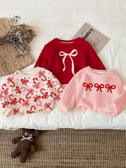 SHEIN Esquema de color navideño, lazo lindo y de moda, estampado de corazón de bastón de caramelo dulce, blanco crema, rosa cuento de hadas, rojo Angola, sudadera casual de cuello redondo para niña adecuada para uso diario en otoño/invierno, Navidad, Año Nuevo, estilo callejero, hogar, vacaciones