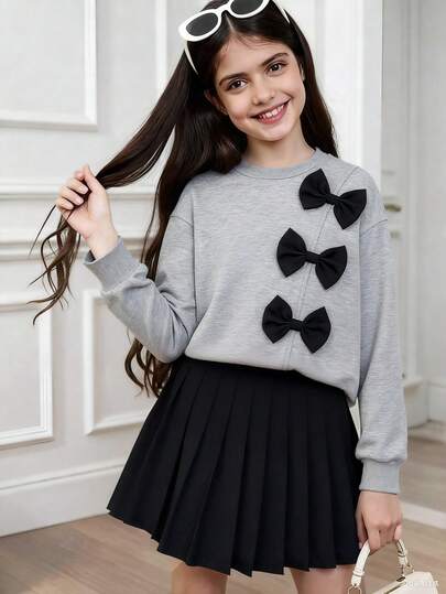 Sparklyn Set de 2 piezas: Sudadera de manga larga color caqui con acento de lazo y falda mini plisada negra