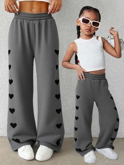 SHEIN Pantalones casuales de unicolor con ajuste holgado y diseño de corazón para niña