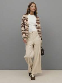 Nöista Cream Corduroy Wide-Leg Pants With High-Rise Fit, Front Patch Pockets, And A Straight Cropped Hem For A Relaxed Yet Polished Silhouette. Perfect For Fall And Winter Outfits - Pair With Knits, Blouses, Or Tailored Outerwear For Chic Everyday Style, City Strolls, Or Casual Gatherings.