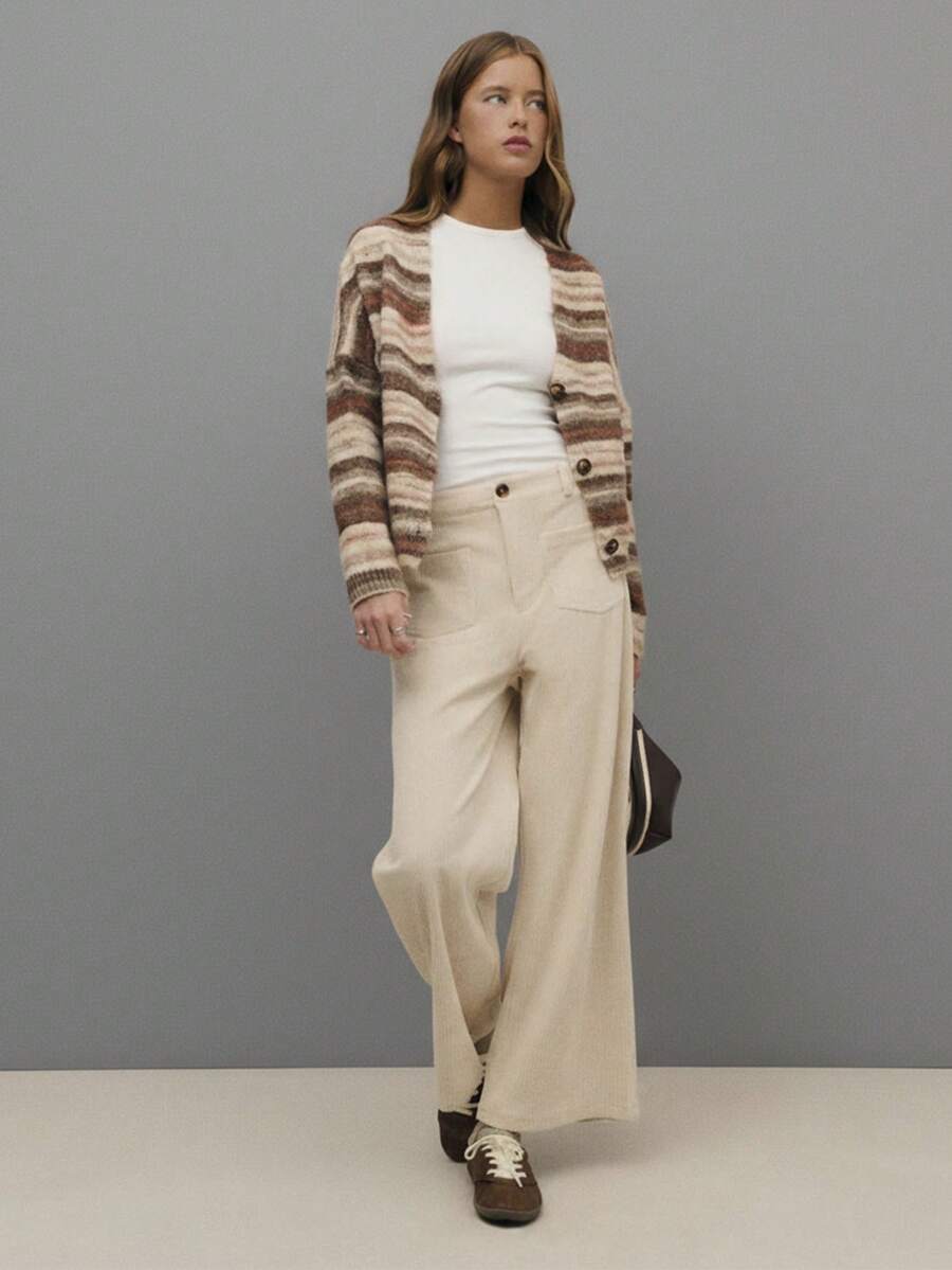 Nöista Cream Corduroy Wide-Leg Pants With High-Rise Fit, Front Patch Pockets, And A Straight Cropped Hem For A Relaxed Yet Polished Silhouette. Perfect For Fall And Winter Outfits - Pair With Knits, Blouses, Or Tailored Outerwear For Chic Everyday Style, City Strolls, Or Casual Gatherings.