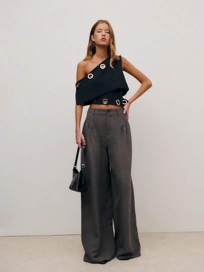 Nöista One-Shoulder Asymmetrical Top With Metal Eyelet Details And A Cropped Fit. A Statement Party Top For Women, Perfect For Elegant Outfits, Christmas Looks, New Year Parties, And Chic Night-Out Styling. Easy To Pair With Tailored Pants Or Skirts For A Modern, Fashion-Forward Look.