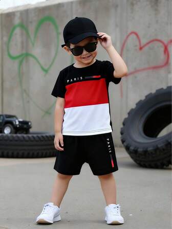 Fantacosmos Set de 2 piezas de camiseta de manga corta con cuello redondo y estampado gráfico a rayas con letras de París y pantalones cortos negros para niños pequeños, conjunto de ropa casual de primavera/verano, adecuado para uso diario en interiores y exteriores de 4 a 6 años de edad