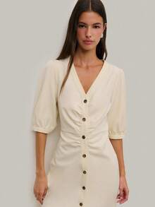 Nöista 这款优雅的中长连衣裙以其挺括的廓形和纽扣细节，打造出精致的正式造型。无论是春假聚会、叠穿搭配，还是生日派对等场合，它都是完美之选。这款优雅的连衣裙与靴子或高跟鞋都能完美搭配，打造出精致的春假造型。 - 米色 - 查看 5