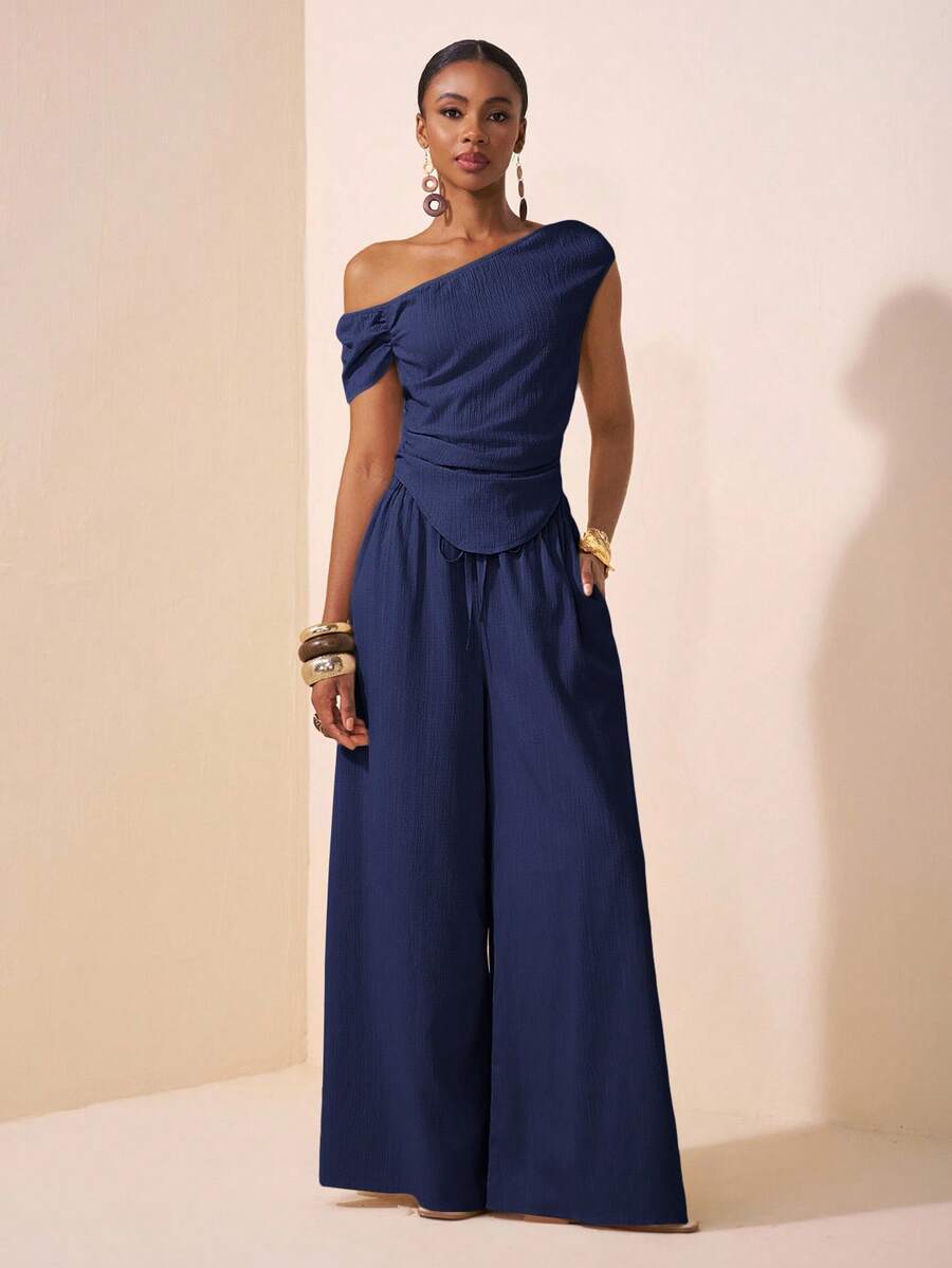 Zivah Lễ hội âm nhạc Xuân/Hè 2025 mới đến, Lễ Phục sinh, Ngày Thánh Patrick, Phong cách miền Tây, Du mục, Tiệc sinh nhật, Lễ tốt nghiệp, Phong cách đại học, Sinh viên, Thường ngày, Cơ bản Đa năng, Giải trí, Kỳ nghỉ, Du lịch du thuyền, Bãi biển, Tắm nắng, Lan truyền, Thời trang đường phố, Khách dự tiệc cưới Boho, Đi làm, Ăn trưa, Trang phục sân bay - Bộ 2 món áo crop top nhún gấu cong màu mơ và quần ống rộng vải họa tiết - Màu xanh hải quân - Xem 1