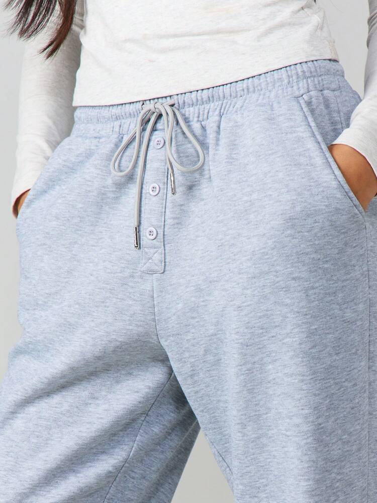 MISSGUIDED Jasnoniebieskie spodnie dresowe ze ściągaczem, guzikami i elastycznymi mankietami, idealne na co dzień, na zimę i wiosnę