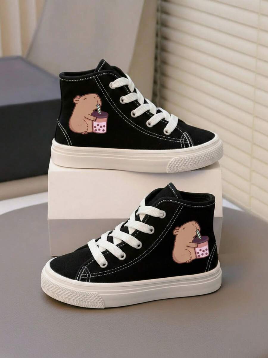 Tenis botín infantiles de tela con gráficos perfectos para actividades escolares, paseos, días casuales y juegos al aire libre. Agujetas blancas y gráficos laterales divertidos, que aportan estilo, dinamismo y personalidad al outfit diario. Fabricados en lona transpirable de alta resistencia, con suela de caucho flexible. Estilo urbano, deportivo y casual, ideal para la temporada Primavera-Verano, combinando fácilmente con jeans, shorts o joggers. Capibara tenis niña - Negro2 - Ver 1