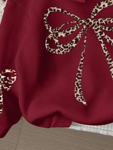 SHEIN Leap Crew Áo nỉ dài tay dáng rộng, có mũ, họa tiết da báo cổ điển, trang trí nơ, dành cho bé gái tuổi teen, thích hợp cho mùa thu/đông, mang hơi hướng cổ điển, cảm hứng Giáng sinh, kiểu dáng cơ bản, thoải mái, ấm áp, áo nỉ kiểu Maillard với nơ cho mùa thu và mùa đông. - Nhiều màu - Xem 5