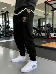 Manfinity Sport Corelite Pantalon de sport pour hommes avec cordon de serrage à la taille, imprimé lettres et crâne, avec poches - Noir - Voir 3