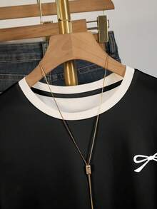 Resyla Áo thun nữ tay ngắn họa tiết nơ, thiết kế họa tiết tương phản đen trắng, thời trang và mặc ngoài trời - màu đen - Xem 3