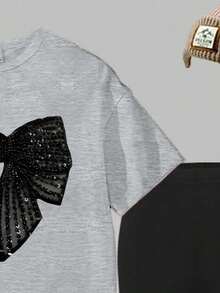 1 set T-shirt à manches courtes avec imprimé nœud à paillettes faux et leggings, style décontracté et confortable pour les jeunes filles. Convient pour les sorties, les sports et l'école, idéal pour l'été.