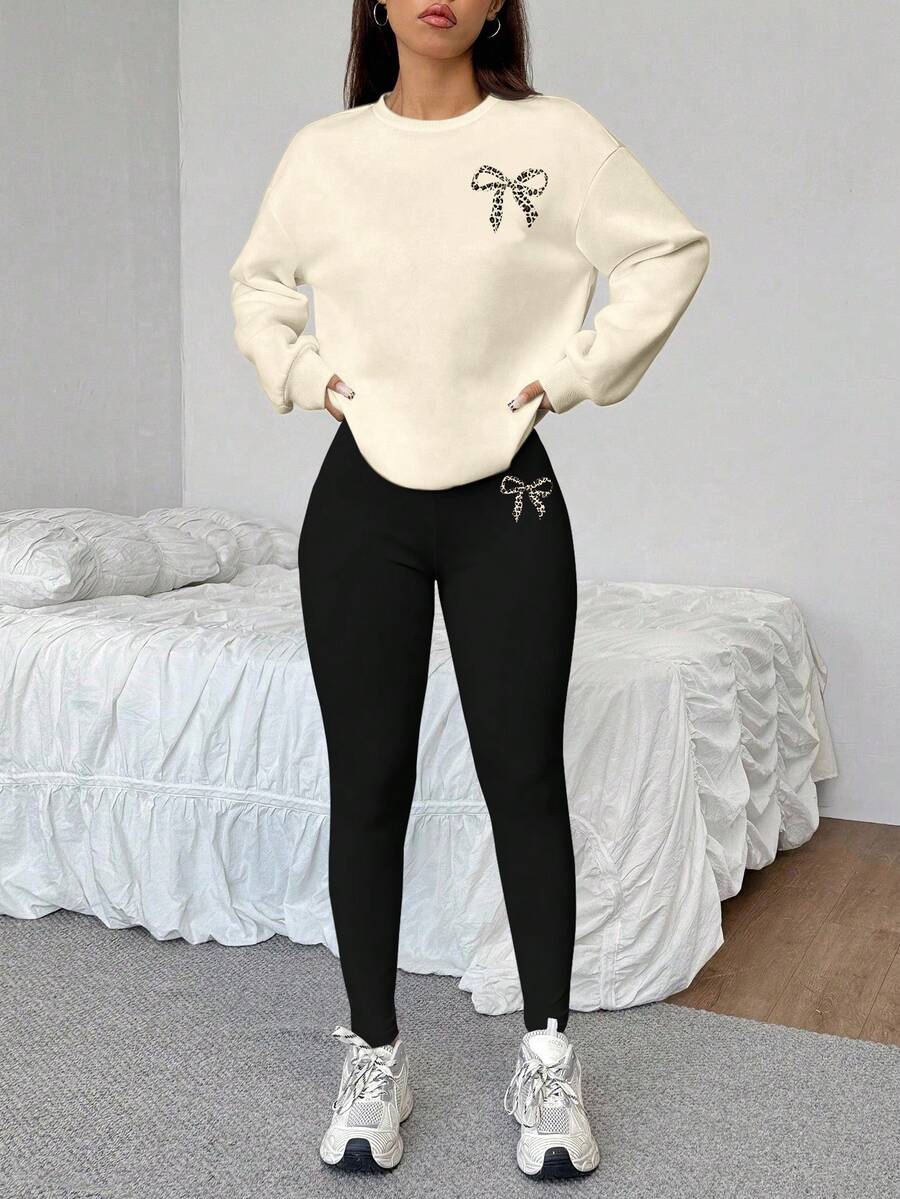 SHEIN EZwear Conjunto informal minimalista de 2 piezas para deportes, calle, fiesta, aeropuerto, con estampado de leopardo y lazo, sudadera holgada de cuello redondo en color amarillo claro y leggings negros ajustados, adecuado para otoño/invierno - Multicolor - Ver 1