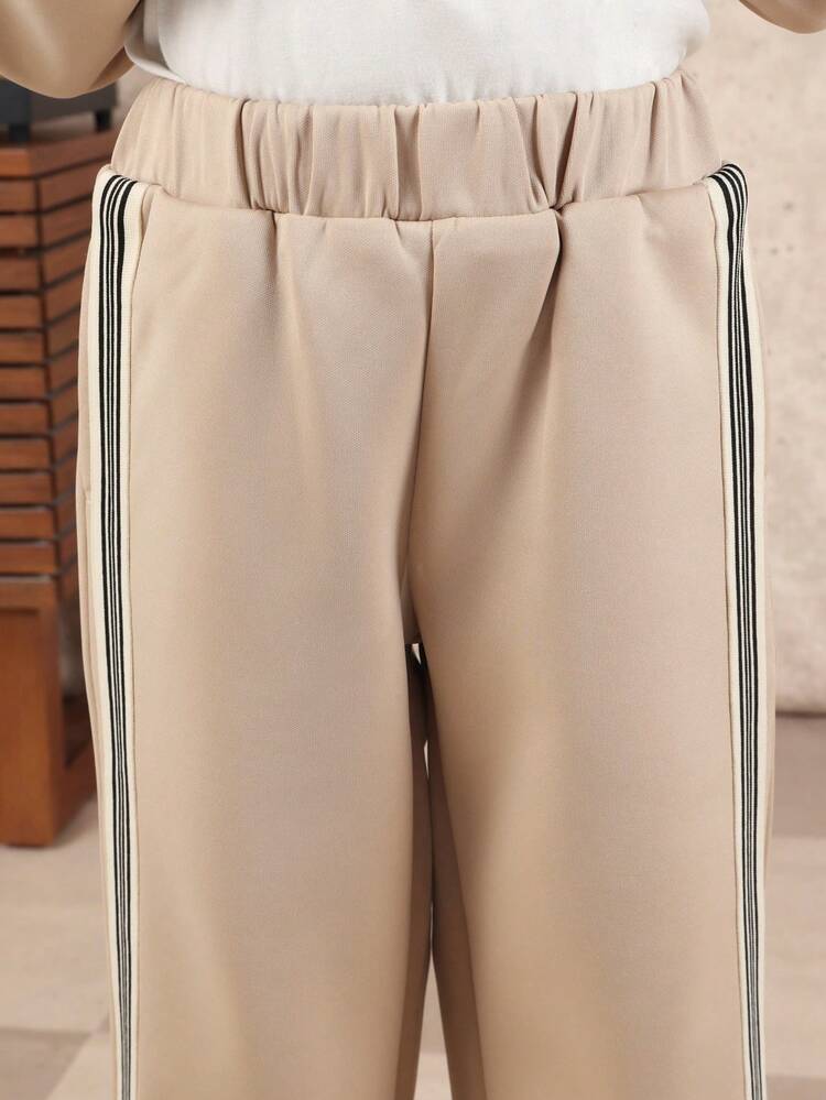 Beigefarbenes Hemd und Jogginghose mit schwarzen Streifen