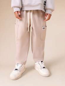 SUMWON Pantalones de chándal casuales con cordón y bolsillos laterales para niños, ajuste relajado y cómodo, para usar en otoño, invierno y días de descanso - Albaricoque - Ver 1