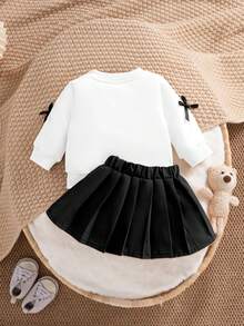 SHEIN Bộ 2 món đồ thường ngày dễ thương cho bé gái sơ sinh, áo nỉ dài tay màu vàng có nơ trang trí hình quả đào kết hợp với chân váy xếp ly màu nâu nhạt, thích hợp mặc hàng ngày, đi học, chụp ảnh, dự tiệc - màu đen - Xem 2