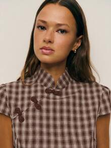 Nöista Spring Break Outfits Dress Features A Retro, Neo-Chinese Style, A Cheongsam Silhouette, A Stand Up Collar, A Slanted Lapel, HandMade Button Detailing. The Buttons Are A Bright, Creating A Striking Contrast Against The Checke Background, Adding A Visual Focal Point, A Touch Of Chinese Flair. The Slim Fit Emphasizes The Woman's Curves. The High Side Slit, Diagonal Rows Of Buttons Create A Playful, Lively Effect. - Coffee Brown - View 7