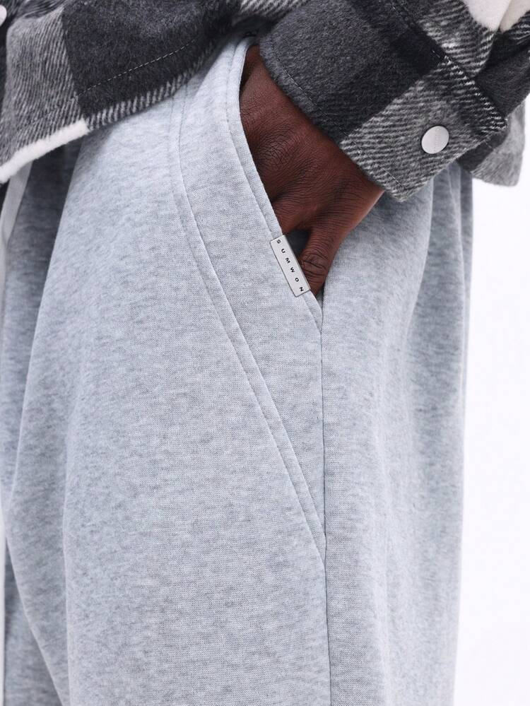 Pantalones deportivos jaspeados con cordón y bolsillos