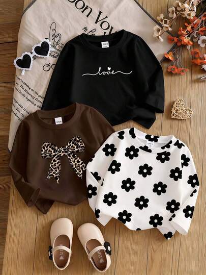 3 piezas Blusas casuales de uso diario para bebé niña, con estampado de leopardo, moño, corazón de amor, flor negra sobre blanco, 3 diferentes esquemas de color (negro, blanco, marrón), cuello redondo de punto de manga larga