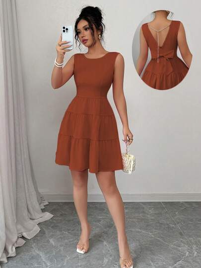 Elenzga 女士纯色圆领连衣裙，后腰处饰有蝴蝶结，下摆饰有荷叶边，无袖设计，优雅迷人。