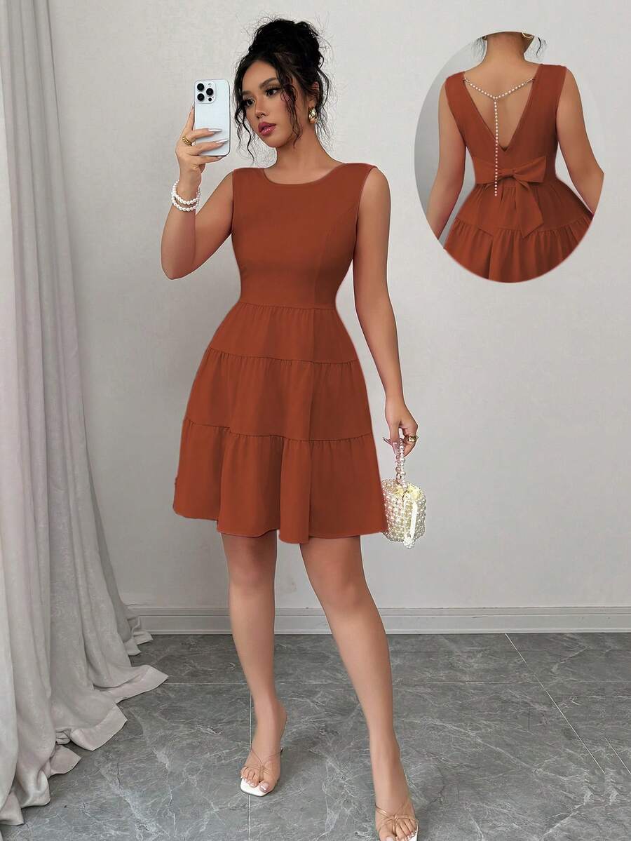 Elenzga Gaun Wanita Polos Leher Bulat dengan Hiasan Pita di Bagian Belakang Pinggang dan Hem Bergelombang, Tanpa Lengan dan Elegan - Rust Brown - View 1