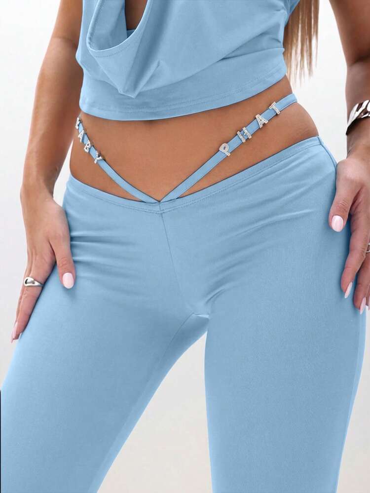 BABYPHAT Flared Trousers With Cutout Waist Details And Adjustable Straps For Casual Chic Style