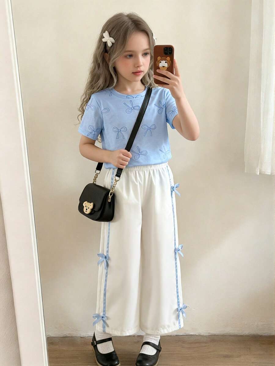 Elladie kids 女童T恤套装,圆领短袖上衣饰有印花蝴蝶结,搭配侧边系带蝴蝶结休闲裤,宽松版型,蝴蝶结细节,休闲优雅风格,适合夏季外出穿着。 - 藍色 - 查看 1