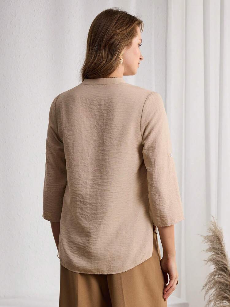This Women's Casual Spring/Summer Shirt Features A Soft, Light Apricot Color That Exudes A Gentle And Sophisticated Feel, Making It A Versatile Base For Stylish Looks. The Floral Pattern Is Crafted From Textured Fabric With A Simple Cut, Revealing A Refined Quality In Its Understated Elegance. The V-Neck And Mid-Length Sleeves Create A Relaxed Silhouette, With Roll-Up Sleeves Suitable For Various Occasions. The Loose Fit Ensures Both Comfort And Casualness. Perfect For Spring And Autumn, This Shirt Is Suitable For Both Work And Casual Outings. The Light Apricot Base Conveys An Elegant Style While The Simple Design Showcases A Fashionable And Professional Look, Making It A Practical And Comfortable Choice For Any Wardrobe.