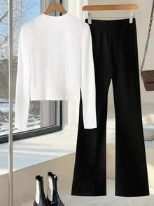 GlowEve CURVE Bộ đồ hai mảnh đen trắng dài tay dành cho nữ gồm áo khoác cardigan trắng thắt nơ và quần dài đen. - Đen và trắng - Xem 2