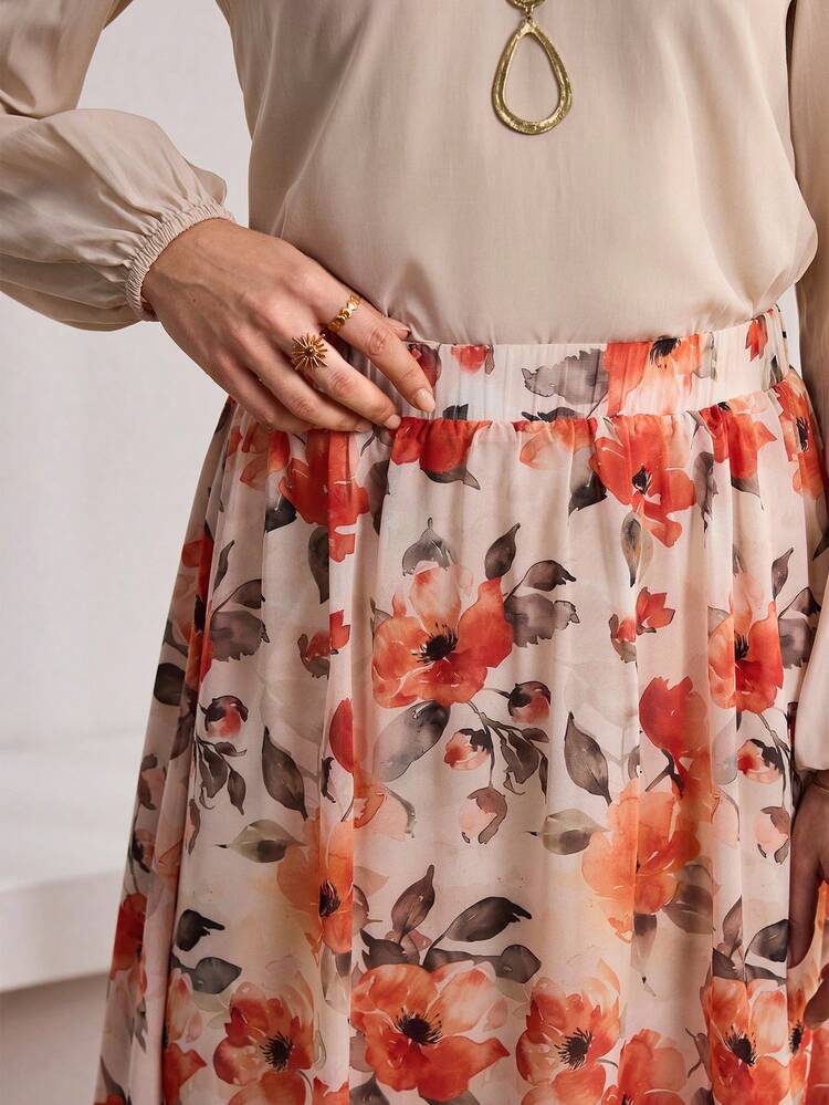 This Elegant Two-Piece Women's Set Features A Soft, Light Apricot Top Paired With A Pink-Based Red Floral Skirt. It Perfectly Captures The Warm Atmosphere Of The New Year While Exuding A Fresh And Fashionable Vibe. The Bright Red Floral Pattern Is Vibrant Yet Gentle. The V-Neck Loose-Fitting Top And Flared Skirt Are Accentuated By A Wide Belt To Define The Waistline, Offering Comfort, A Slimming Effect, And Elegance. Suitable For Spring And Autumn, This Set Can Be Accessorized With Jewelry To Brighten The Look Or Layered With A Jacket For Added Depth. Perfect For Youthful Gatherings And Casual Occasions, This Set Combines The Vibrancy Of Red Florals With A Gentle, Fashionable Touch, Making It A Versatile Piece For Your New Year's Wardrobe That Blends Energy And Femininity.
