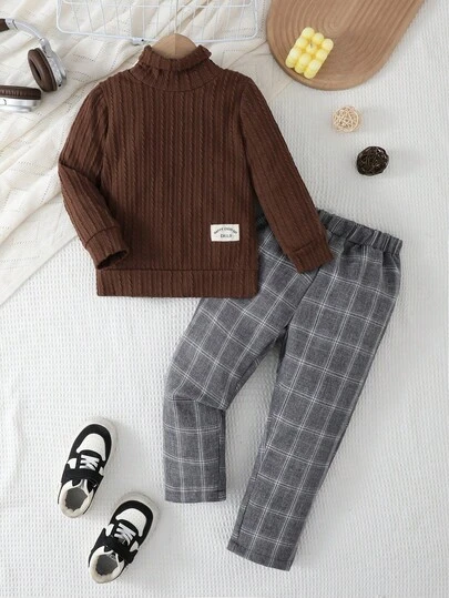 SHEIN Vintaside Kids 2pcs Young Boy Casual Outfit, Black Ribbed Sweater + Plaid Pants, Paired With White Sneakers, Showcasing Cute And Style! The Classic Black Top Adds Depth And Vitality. Paired With Fashionable Gray Plaid Pants, The Overall Look Is Casual Yet Refined. Stepping Into White Sneakers, Easily Creating A Vibrant And Energetic Young Boy Image, Allowing The Child To Express Their Unique Personalized In Happiness!