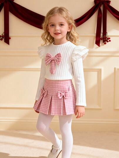 Souflis 两件套少女优雅套装，包括粉色千鸟格半身裙和白色罗纹针织荷叶袖上衣，饰有蝴蝶结，适合日常穿着、生日派对等场合，展现甜美迷人的公主气质。