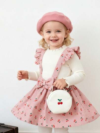 Souflis Souflis Ensemble fille bébé/tout-petit avec t-shirt blanc à manches longues basique style rétro français pour l'automne/hiver, assorti à une jupe salopette imprimée de cerises mignonnes. Convient pour les sorties, l'école, les jeux et diverses occasions.