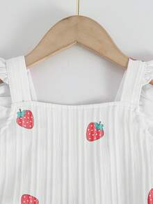 Elladie kids 一件白色无袖樱桃印花连体裤，采用背带设计，饰有荷叶袖和红色滚边，风格可爱清新，适合日常穿着，宽松版型方便活动，是休闲、轻度户外活动、返校季以及春夏的理想之选。 - 白色 - 查看 6