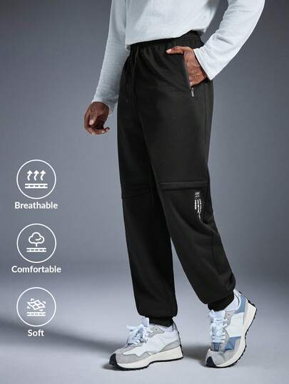 Driftmere 男士休闲运动裤一条，修身剪裁，裤脚收口（根据款式不同，可译为“卷边”或“收脚”，此处为准确起见保留原文，但“卷边”是更常见的说法），适合居家和户外活动穿着，也可作为情侣礼物。采用100%聚酯纤维面料，配有抽绳腰带，方便调节松紧，多种颜色可选。适合春夏穿着。