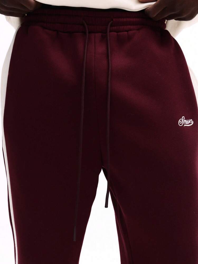 Flared Sweatpants With Side Stripes And Script Logo