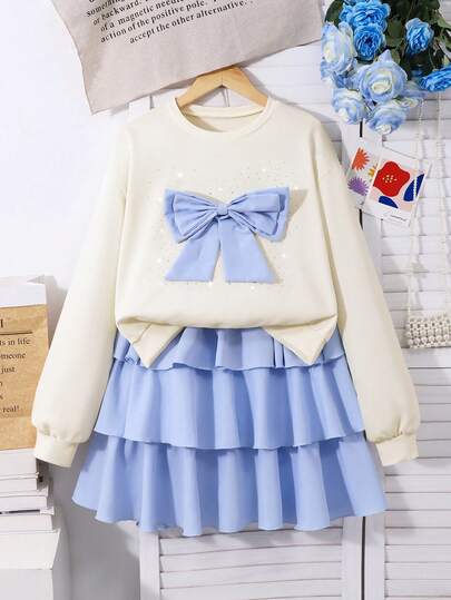 SHEIN 少女3D蝴蝶结装饰水钻长袖卫衣和蛋糕裙套装，适合日常休闲穿着和学生装扮。