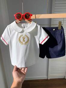 SHEIN 2pcs Baby Boy Preppy Style Embroidered Pattern Peter Pan Collar Short Sleeve Shirt & Elastic Waist Shorts Gentleman Outfit Set, Suitable For Birthday Party, Rave, Evening Party, Performance, Wedding, Baby Shower, And 1st Birthday Celebration Baby Boy Summer Outfit Baby Boy Casual Shorts Baby Boy Sailor Outfit Baby Boy Short Sleeve Set Baby Boy White Polo - Multicolor - View 9