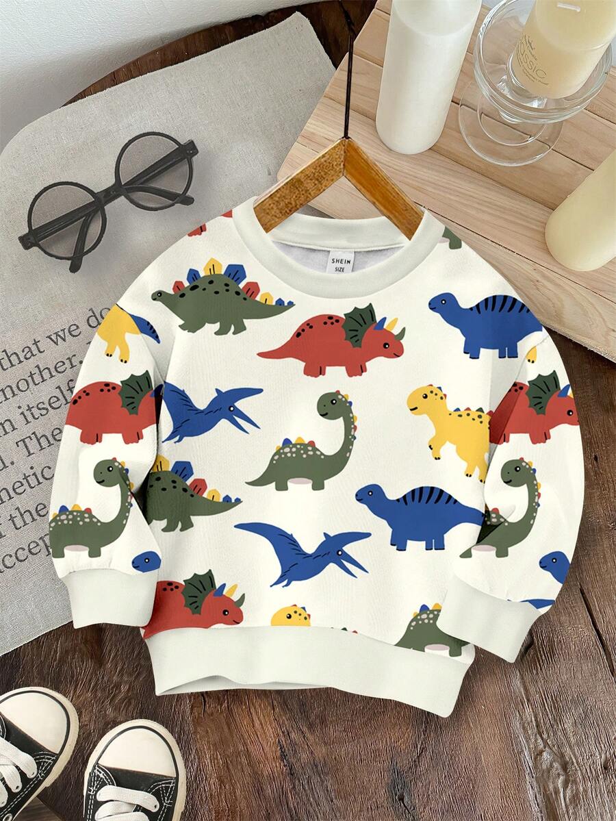 SHEIN 年轻男孩休闲简约卡通恐龙印花宽松圆领舒适针织长袖运动衫，适合秋冬季