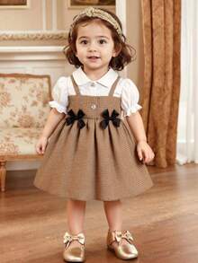 Souflis Souflis 女婴夏季翻领二合一泡泡袖蝴蝶结A字连衣裙。精致的3D蝴蝶结装饰，甜美的泡泡袖设计，经典的A字廓形，适合各种宝宝体型。不仅适合日常居家和休闲散步，也适合外出、购物和打造吸睛造型；同时也是妈妈为宝宝衣橱搭配的必备时尚单品。 - 彩色 - 查看 1