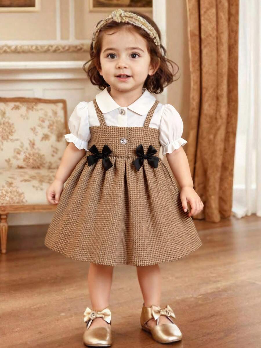 Souflis Souflis 女婴夏季翻领二合一泡泡袖蝴蝶结A字连衣裙。精致的3D蝴蝶结装饰，甜美的泡泡袖设计，经典的A字廓形，适合各种宝宝体型。不仅适合日常居家和休闲散步，也适合外出、购物和打造吸睛造型；同时也是妈妈为宝宝衣橱搭配的必备时尚单品。 - 彩色 - 查看 1