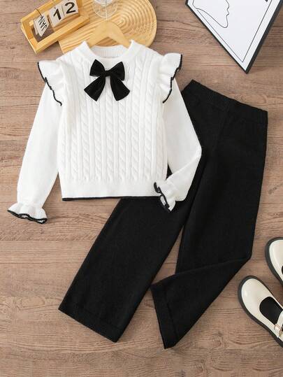 SHEIN Bộ 2 áo len dễ thương cho bé gái (màu trắng) và quần ống đứng (màu đen), được trang trí bằng họa tiết dây thừng xoắn tinh tế và nơ, thích hợp cho mùa xuân/thu và mùa thu/đông, lý tưởng cho trường học, tụ họp, sự kiện gia đình