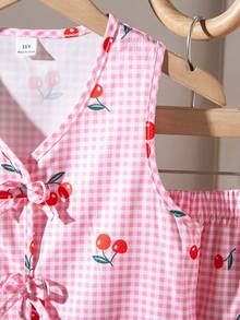 SHEIN This Is A Set For Girls, Consisting Of Two Pieces: A Sleeveless Sweater With Digital Printing In Pink Plaid Pattern And Cherry Motifs, As Well As Loose-Fitting Casual Shorts. The Sweater Features A Bow Decoration, And The Shorts Have An Elastic Waistband. Perfect For Girls This Summer. - Pink - View 6