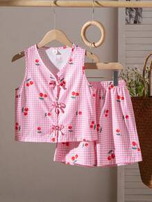 SHEIN This Is A Set For Girls, Consisting Of Two Pieces: A Sleeveless Sweater With Digital Printing In Pink Plaid Pattern And Cherry Motifs, As Well As Loose-Fitting Casual Shorts. The Sweater Features A Bow Decoration, And The Shorts Have An Elastic Waistband. Perfect For Girls This Summer. - Pink - View 9