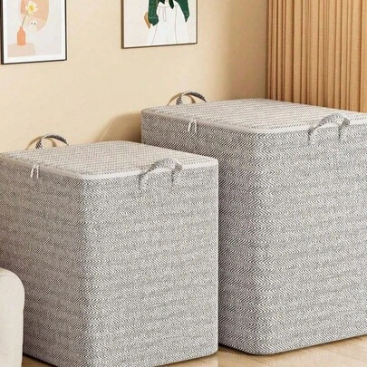 灰色箭头牌收纳袋，采用高强度无纺布制成，可折叠设计，超大容量，适用于衣柜整理、搬家用品和床底收纳。