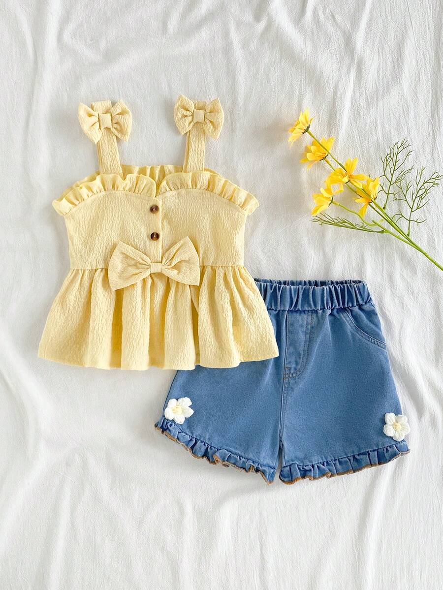 SHEIN Vintaside Kids Younggirl – Ten dwuczęściowy komplet składający się z żółtego topu halter i dżinsowych szortów z wysokim stanem z kieszeniami na wiosnę i lato jest uroczy, uroczy i uniwersalny. Tkanina o średniej grubości, ozdobiona falbankami i trójwymiarowymi kwiatowymi zdobieniami. Guziki z nadrukiem w panterkę dodają charakteru retro. Zestaw nadaje się do szkoły, na wycieczki, na wakacje, do relaksu w domu i na imprezy. - Żółty - Zobacz 1